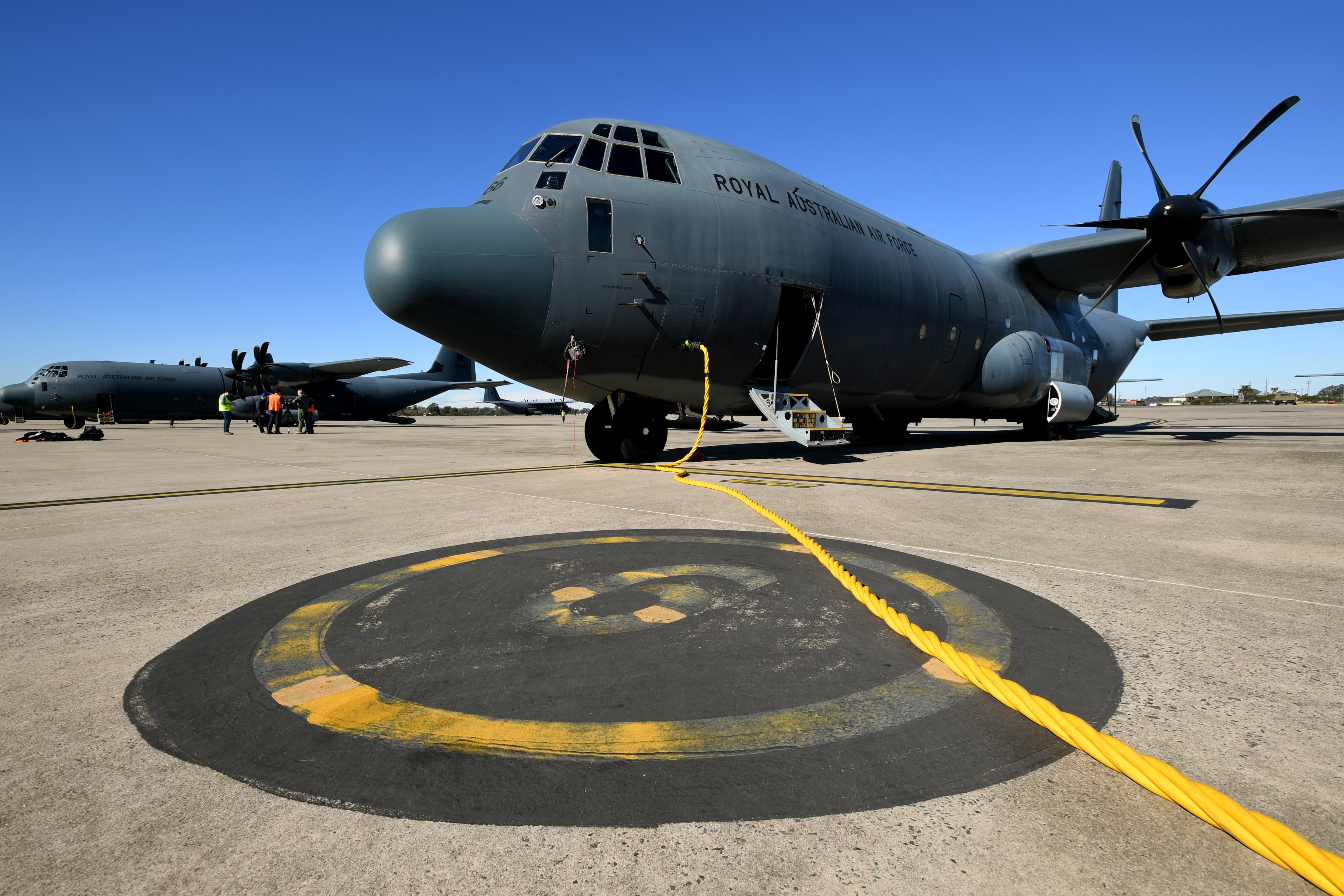 Ground staff prepare Royal Australian Air Force C-130J Hercules aircraft. Defence bosses have warned of the rise of climate refugees. 