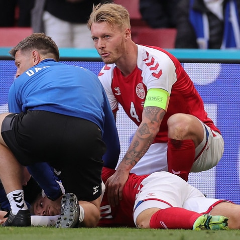 Christian Eriksen receives medical treatment after collapsing during a Denmark match