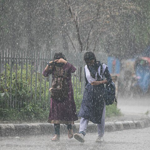 Girls are seen walking amid heavy rainfall on the streets of Dhaka. Heavy monsoon downpour causes extreme water logging in most areas of Dhaka city. Roads are submerged making traveling slow and dangerous. (Photo by Sazzad Hossain / SOPA Images/Sipa USA)