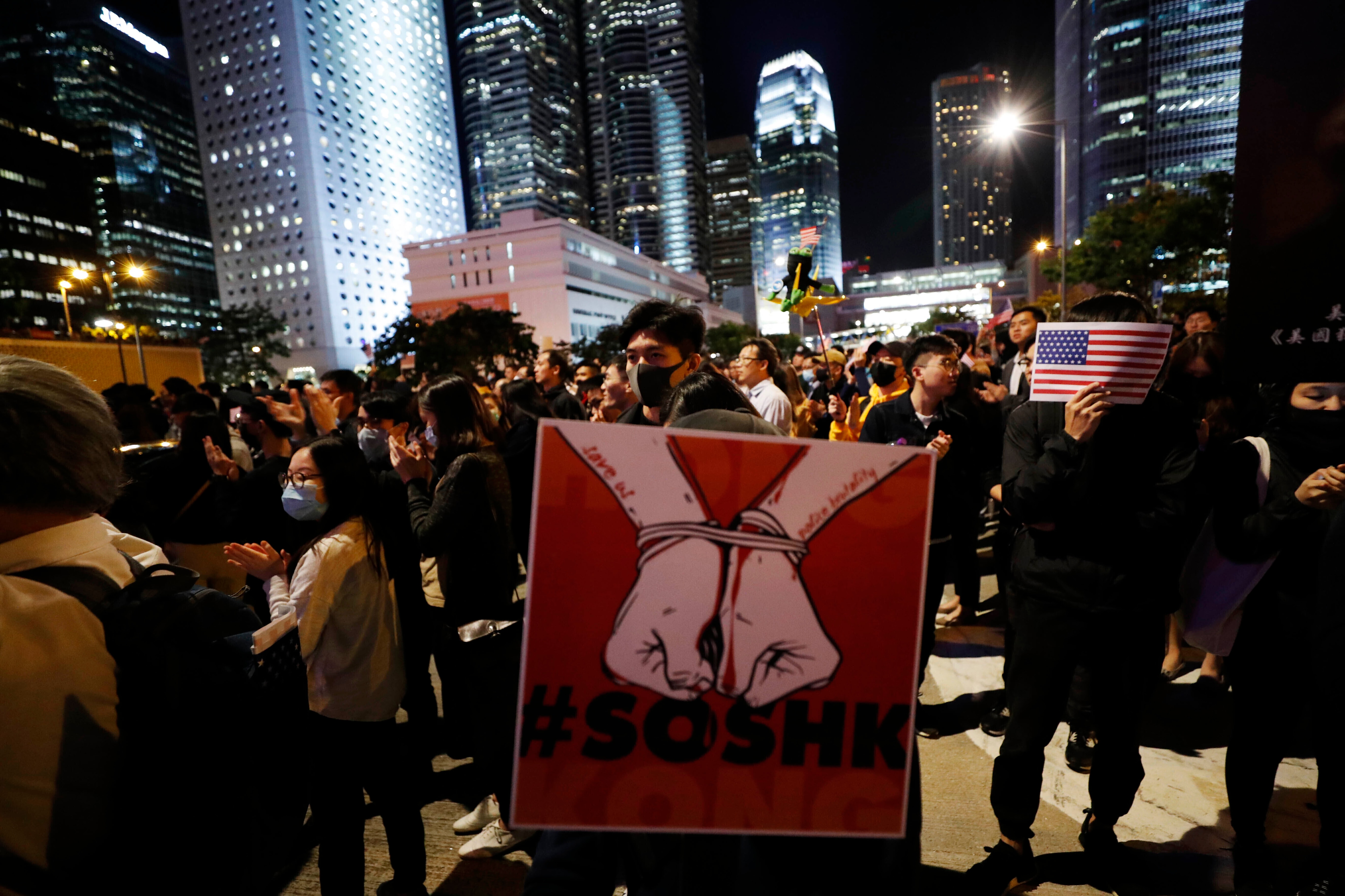 A protester holds a placard showing bound hands during a demonstration in Hong Kong.