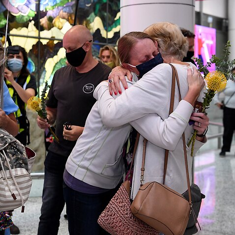 Travellers arriving on the first quarantine free international flights are embraced by family at Sydney International Airport, Monday, November 1, 2021. 