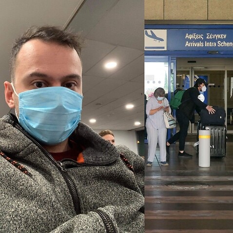man at airport hall wearing face mask - (background) Passengers seen with the obligatory face masks at Athens International Airport