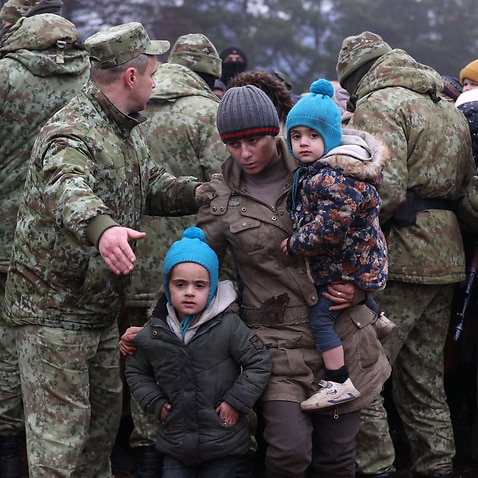 Migrants gather to receive humanitarian aid on the Belarusian-Polish border. 