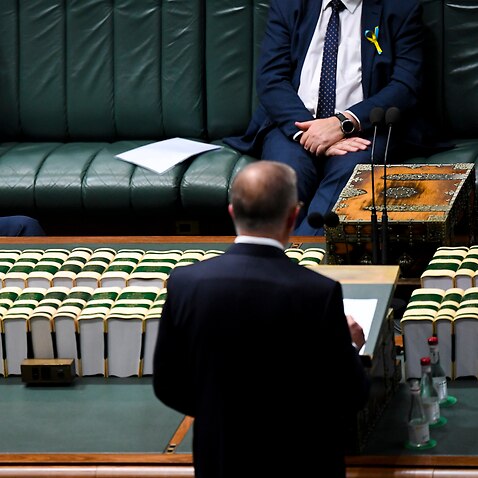 Australian Prime Minister Scott Morrison listens to Federal Opposition Leader Anthony Albanese deliver his Budget Reply Speech in the House of Representatives of Parliament House in Canberra, Thursday, March 31, 2022. (AAP Image/Lukas Coch) NO ARCHIVING