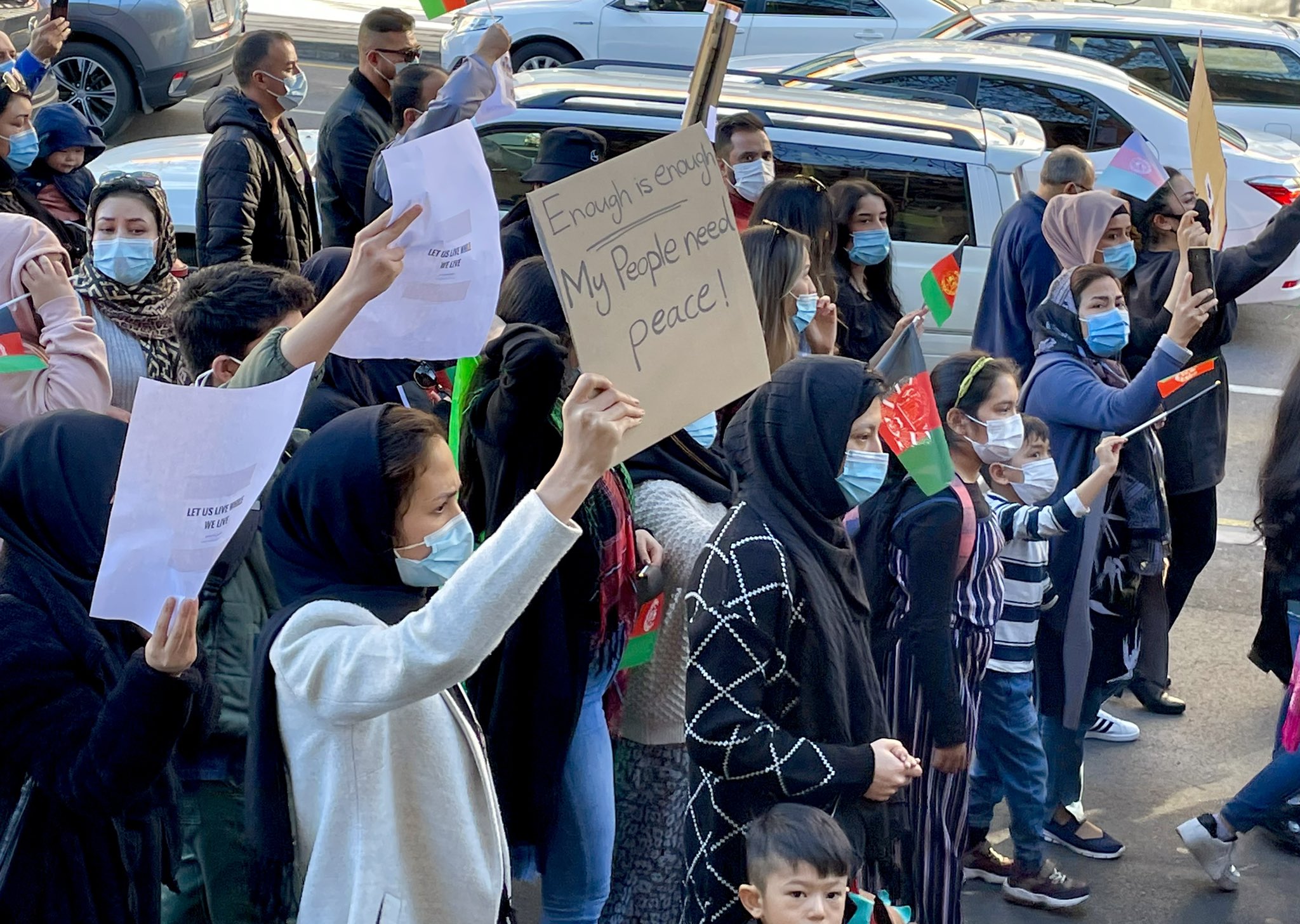 Members of the Afghan community in Adelaide protest on Saturday, urging the Australian government to help those displaced by Taliban violence.