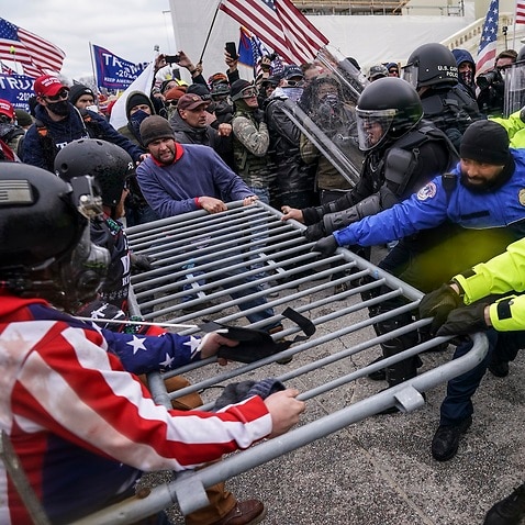 Trump supporters try to break through a police barrier, Wednesday, Jan. 6, 2021, at the Capitol in Washington. 