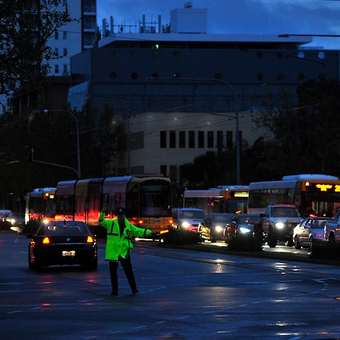 Police direct traffic after a blackout following storms in Adelaide