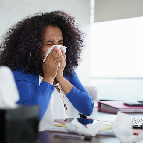 Woman Working from Home And Sneezing For Cold