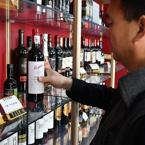 A dealer displays imported Australian wines at a wholesale department of imported wines in Yantai, Shandong Province, Nov. 27, 2020.  