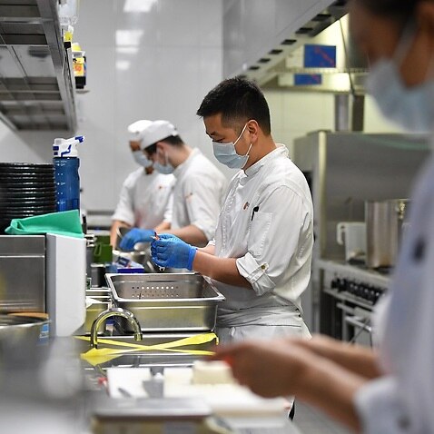 Workers prepare food at Japanese restaurant Nobu at Crown Sydney in Sydney, Sunday, October 10, 2021. From Monday, lockdown restrictions will lift for fully vaccinated people across NSW. (AAP Image/Joel Carrett) NO ARCHIVING
