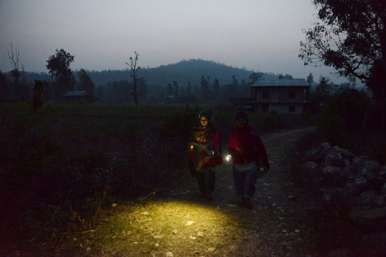 Two Nepalese women walk back after dinner to a Chhaupadi hut during their menstruation period in Surkhet District, some 520km west of Kathmandu.