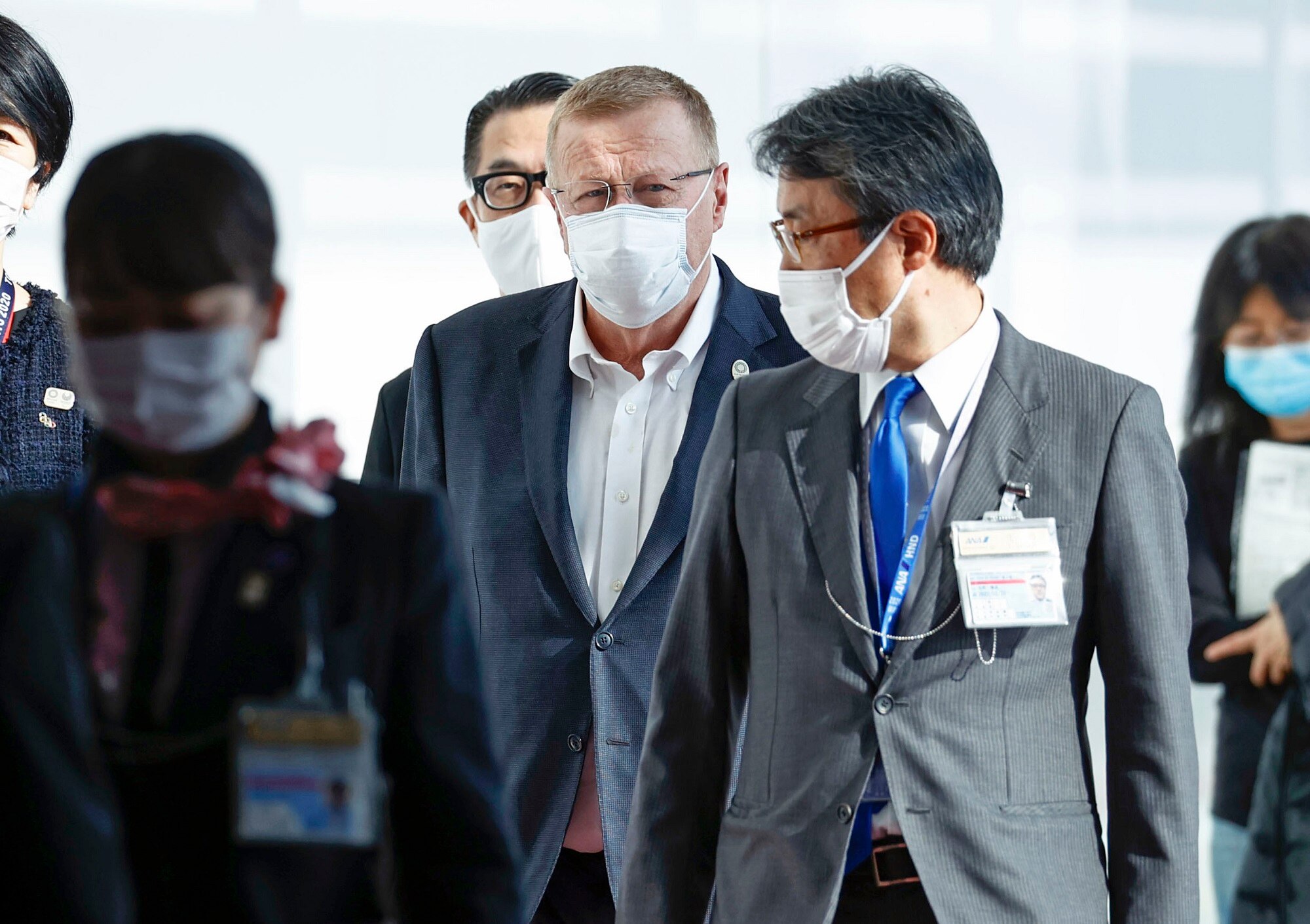 Australian Olympic Committee President and International Olympic Committee Vice-President John Coates (c) arrives at Tokyo's Haneda airport on 15 June 2021. 