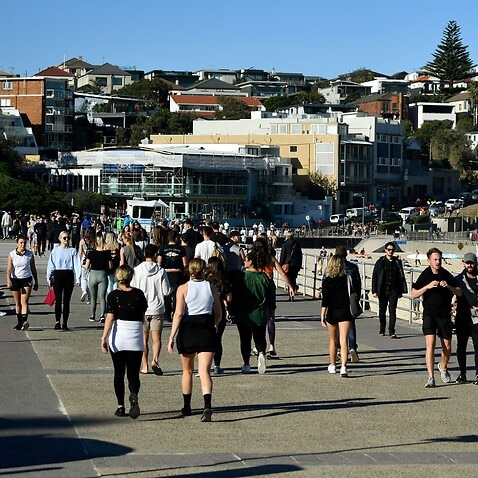 People exercise on the boardwalk at Bondi Beach in Sydney, Sunday, June 27, 2021. More than five million people in Greater Sydney and its surrounds have gone into a 14-day lockdown as health authorities try to regain control of a coronavirus outbreak. () 