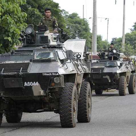 A military convoy passes a checkpoint on the outskirts of Marawi city, southern Philippines