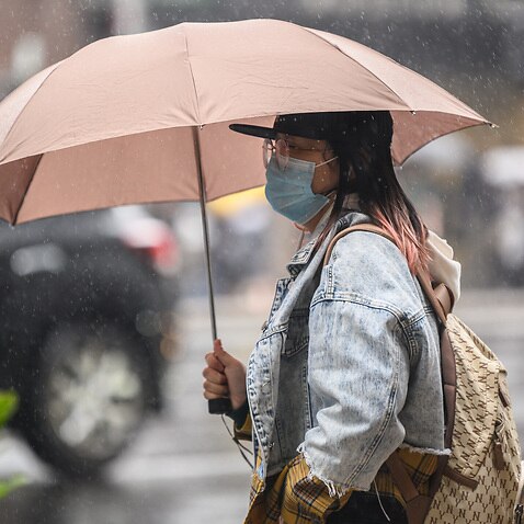 A woman wearing a protective face mask seen in Sydney on Wednesday.