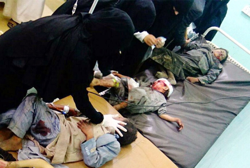 A handout video grab photo made available by the Houthi Movement showing wounded Yemeni children lying on beds receiving treatment 