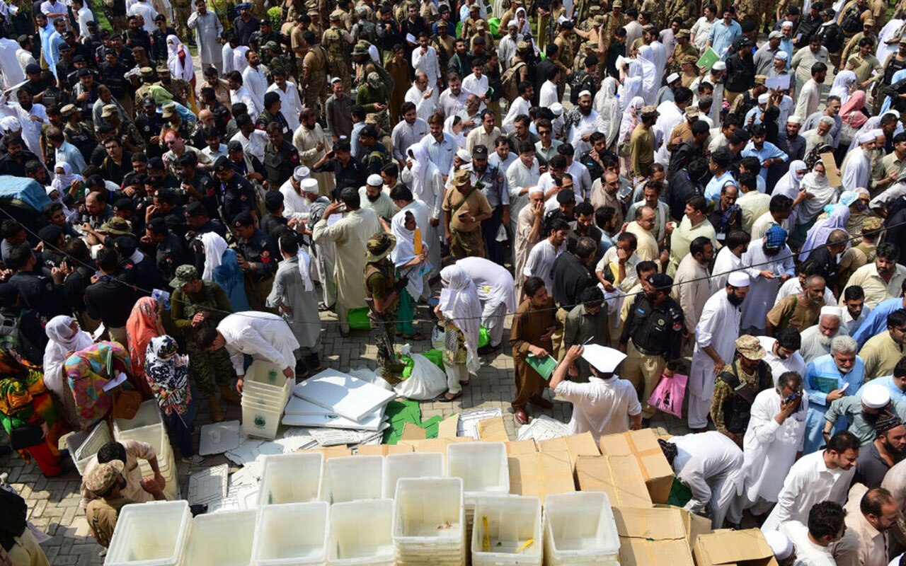 Pakistani election officials receive ballot boxes and voting materials at a distribution centre in Peshawar on July 24, 2018.