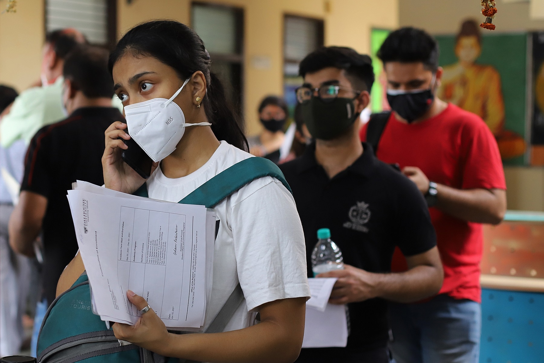 Students and international travelers in Delhi completing paperwork before being vaccinated against Covid-19 (