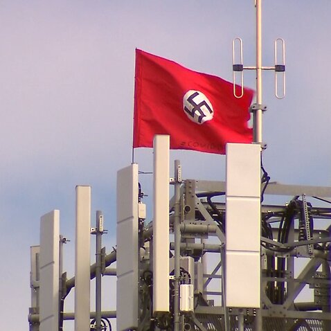 A large swastika has been planted on the top of a phone tower at Kyabram. There are also two Chinese flags being flown from there too.
