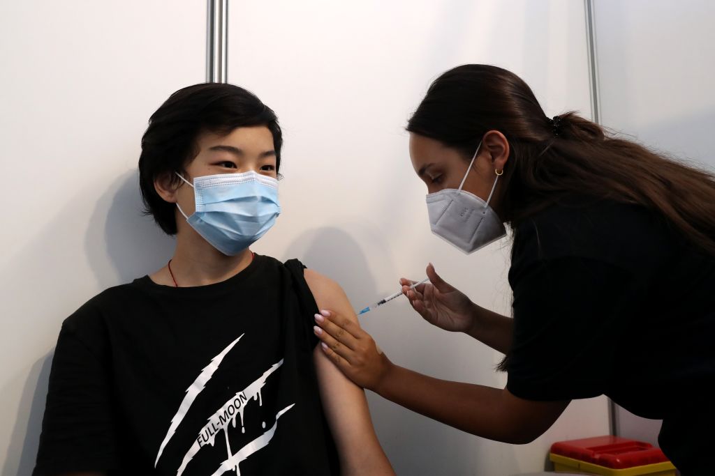A boy receives his first dose of a COVID-19 vaccine at a vaccination center in Oeiras, Portugal.