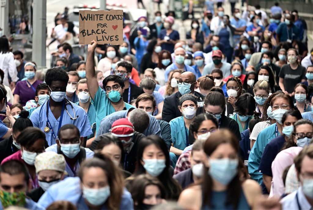 Nurses and healthcare workers attend a Black Lives Matter rally in front of Bellevue Hospital on June 4, 2020, in New York City. (Photo by Johannes EISELE / AFP) (Photo by JOHANNES EISELE/AFP via Getty Images)