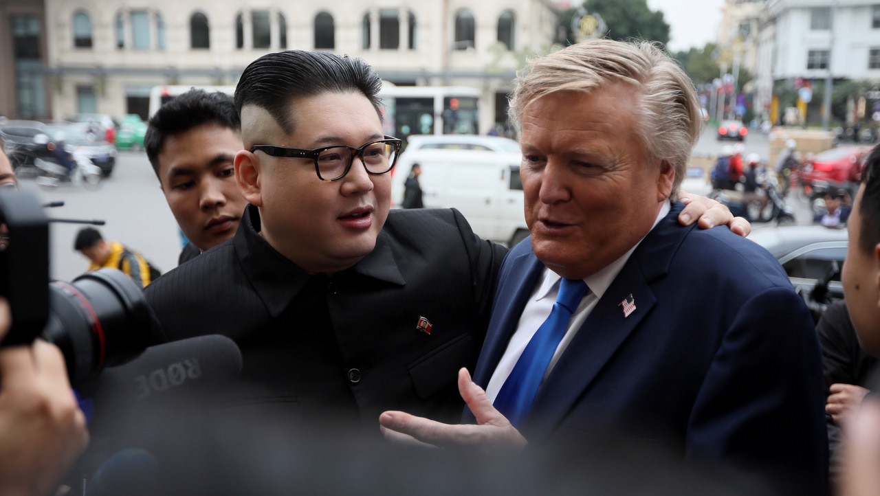 Kim Jong-un impersonator Howard X (L) and Donald Trump impersonator Russell White (R) talk to journalists at the Opera House in Hanoi.