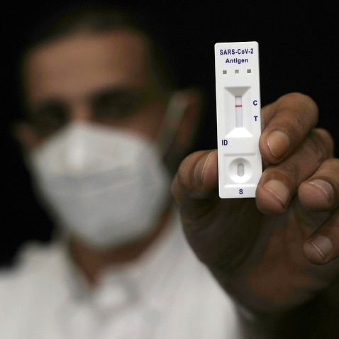A man holds a negative rapid antigen coronavirus test.