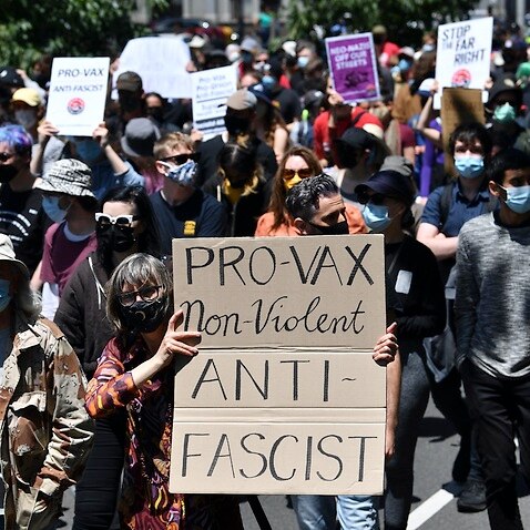 Members of The Campaign Against Racism & Fascism group participate in a counter protest against anti-vaxxers in Melbourne.