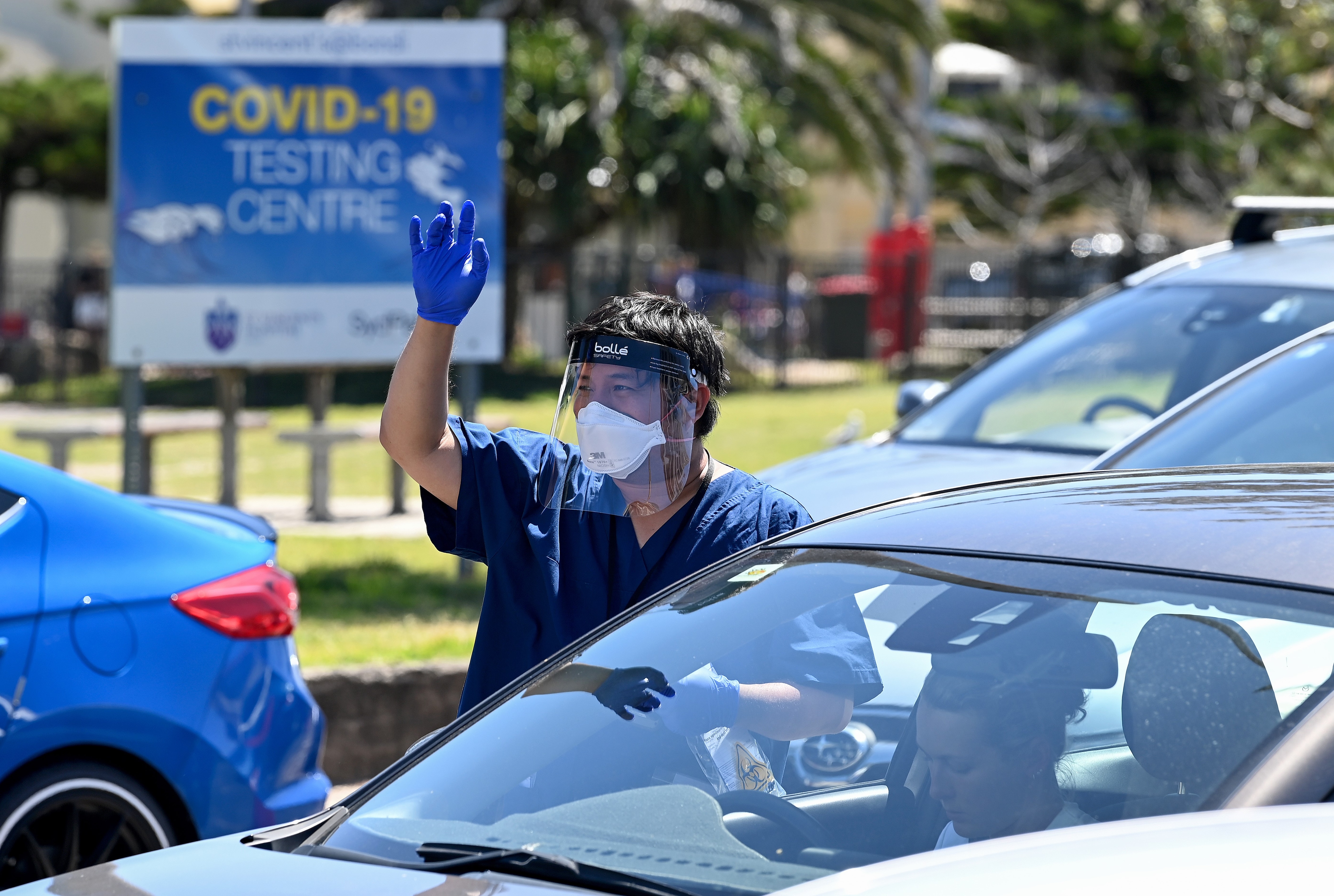 Healthcare workers administer COVID-19 tests at a drive-through testing clinic at Bondi Beach in Sydney.