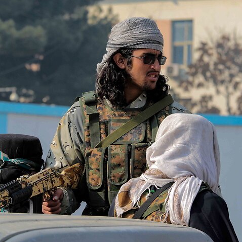  Taliban patrol during a protest by Afghans