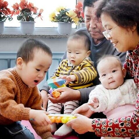 Chinese Family taking care of orphans at home
