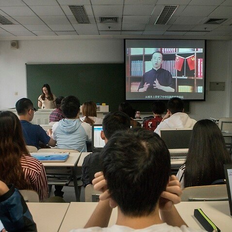 Students watch Feng Wuzhongs online lecture during a course on Maoist ideology at Tsinghua University in Beijing.