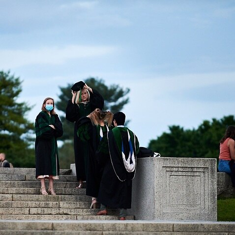 In this photo provided by Geoff Livingston, Georgetown University students and others gather for their own graduation celebration at the National Mall in Washington, Saturday, May 16, 2020. (Geoff Livingston via AP)
