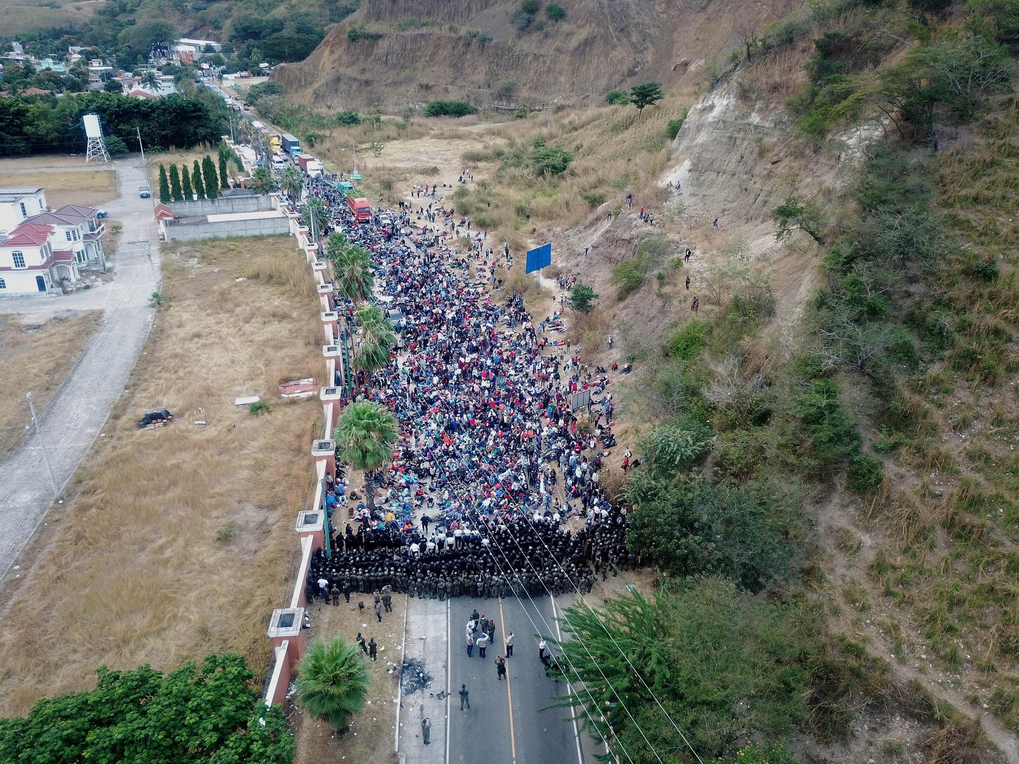 Guatemalan soldiers and policemen form a human barricade to stop Honduran asylum seekers walking on a highway near to Chiquimula, Guatemala.