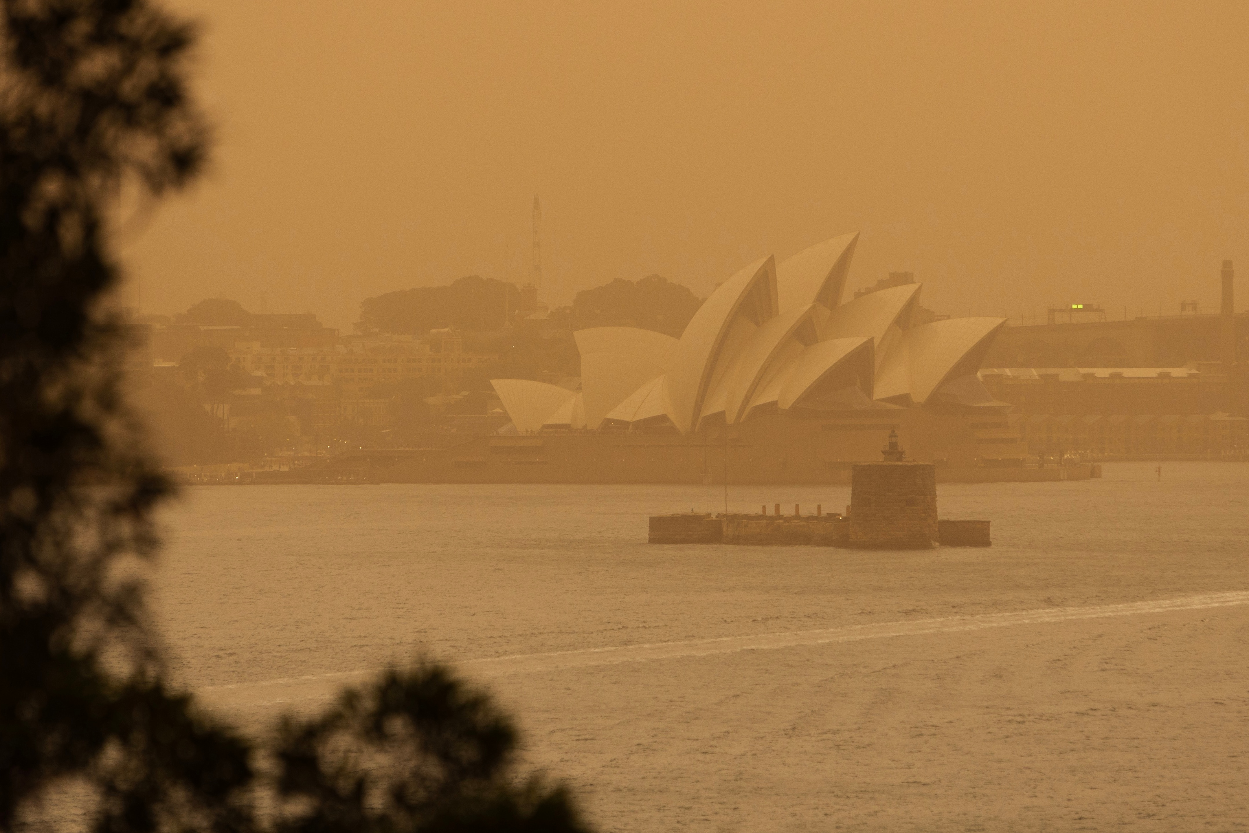 Smoke haze hangs over the Sydney Opera House as fires burn across the state.