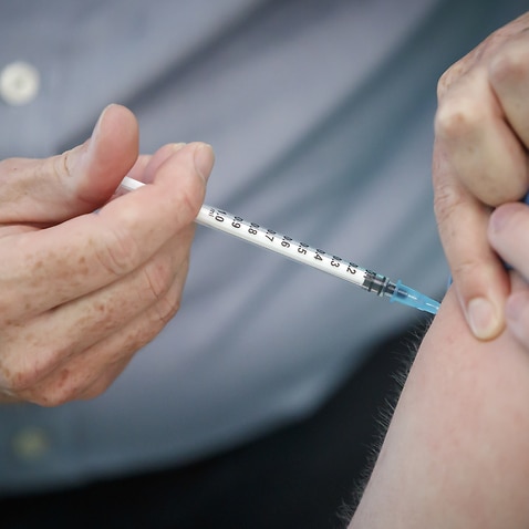 A person receiving the Pfizer-BioNTech COVID-19 vaccine at a vaccination centre in New York. 