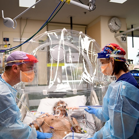 ICU nurse Michelle Spiteri and anaesthetist and intensive care physician Dr Forbes McGain attending to a Covid-19 patient.