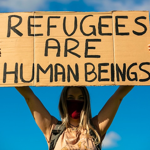 A protester advocates for refugee rights in Brisbane.
