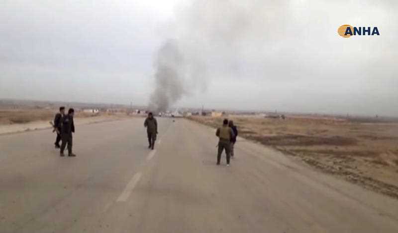 Kurdish fighters standing guard at the site of a suicide attack near the town of Shaddadeh, in Syria's northeastern province of Hassakeh.