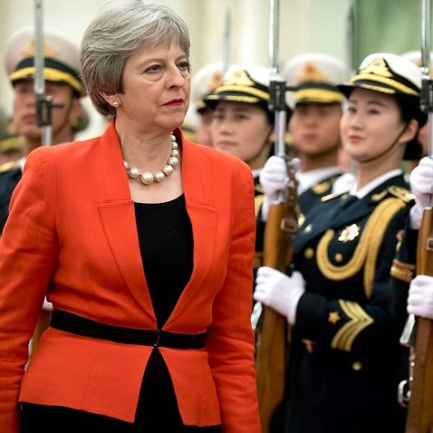 British Prime Minister Theresa May reviews a Chinese ensure of honour during a acquire rite during a Great Hall of a People in Beijing.