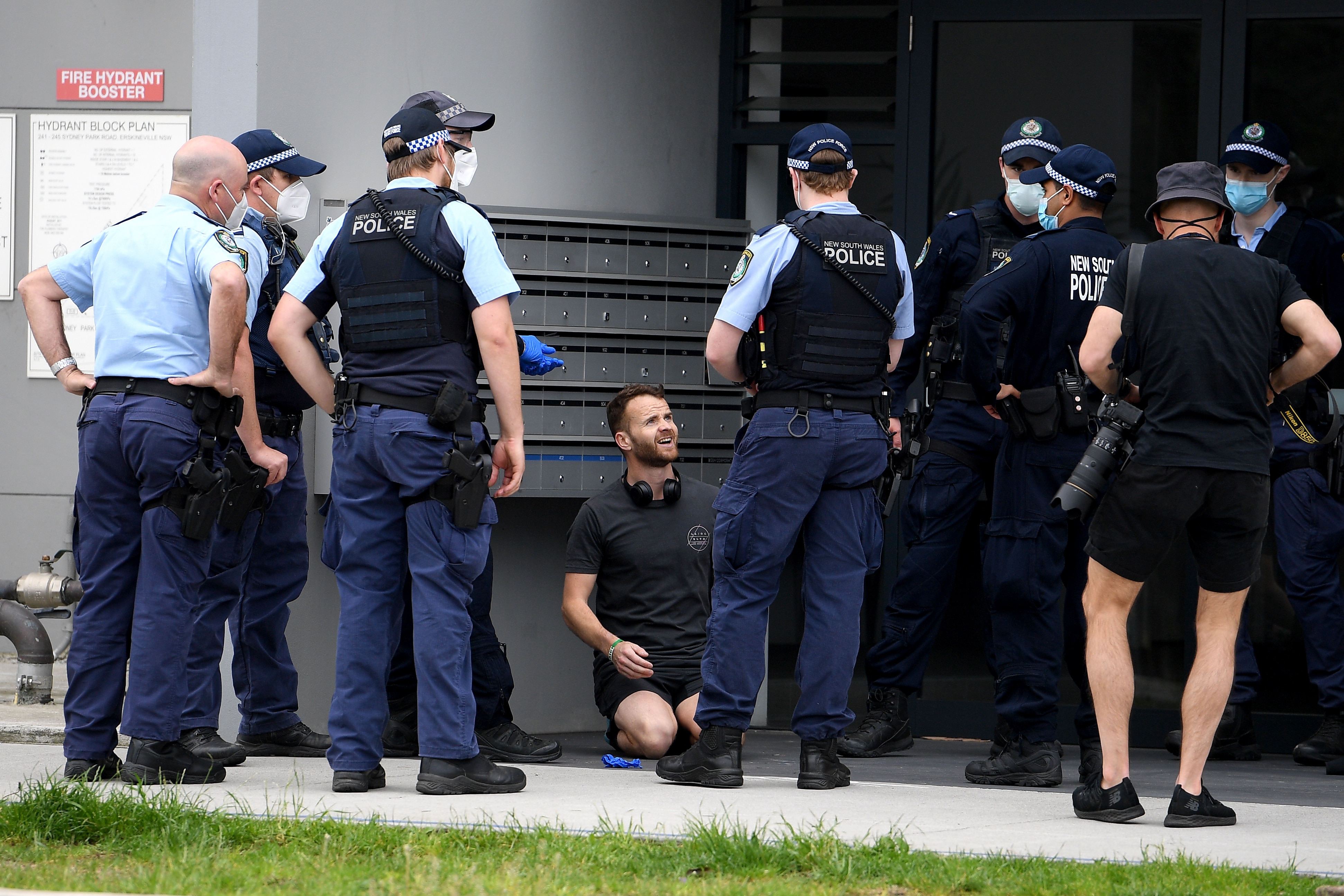 Police apprehend a man ahead of a planned protest at Sydney Park.