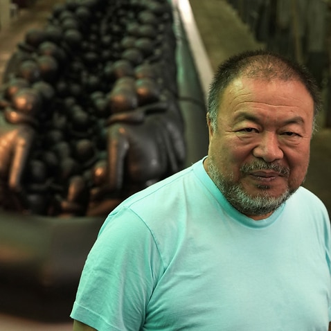 Ai Weiwei in front of his installation 'Law of the Journey'.