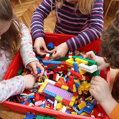 Children playing with lego bricks.