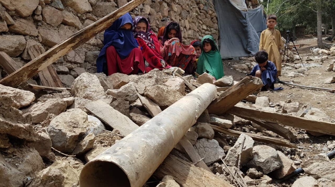 Afghan children are seen near debris after a magnitude 7.0 earthquake shook Afghanistan.s