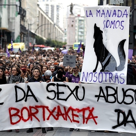 People show a banner reading 'It is not sexual abuse, it is rape' as they attend a protest against the judiciary sentencing on the trial of five men accused of gang raping an 18-year-old during San Fermin fiestas.