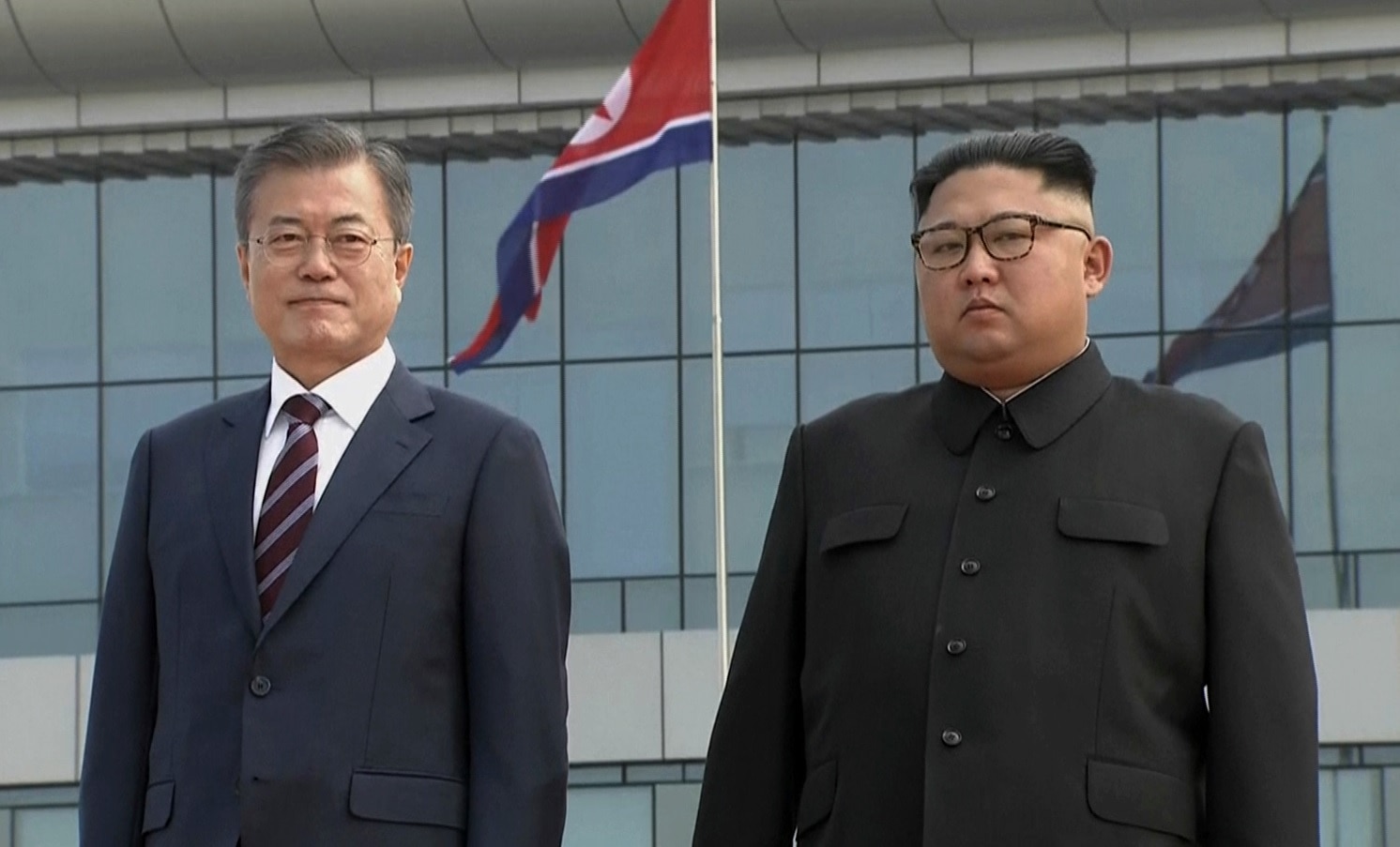 In this image made from video provided by Korea Broadcasting System (KBS), South Korean President Moon Jae-in, left, poses with North Korean leader Kim Jong Un