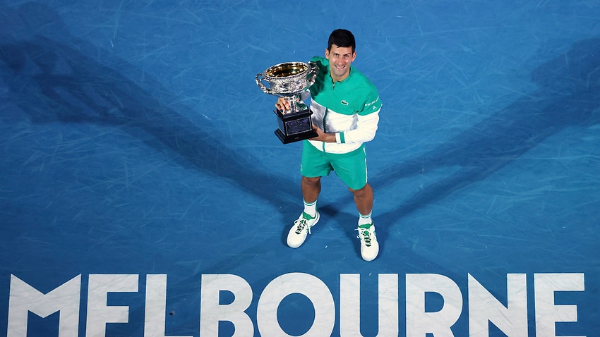 Serbia's Novak Djokovic holds the Norman Brookes Challenge Cup after winning the men's singles final at the Australian Open in Melbourne, 21 February, 2021.