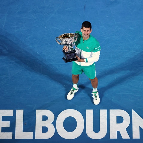 Serbia's Novak Djokovic holds the Norman Brookes Challenge Cup after winning the men's singles final at the Australian Open in Melbourne, 21 February, 2021. 