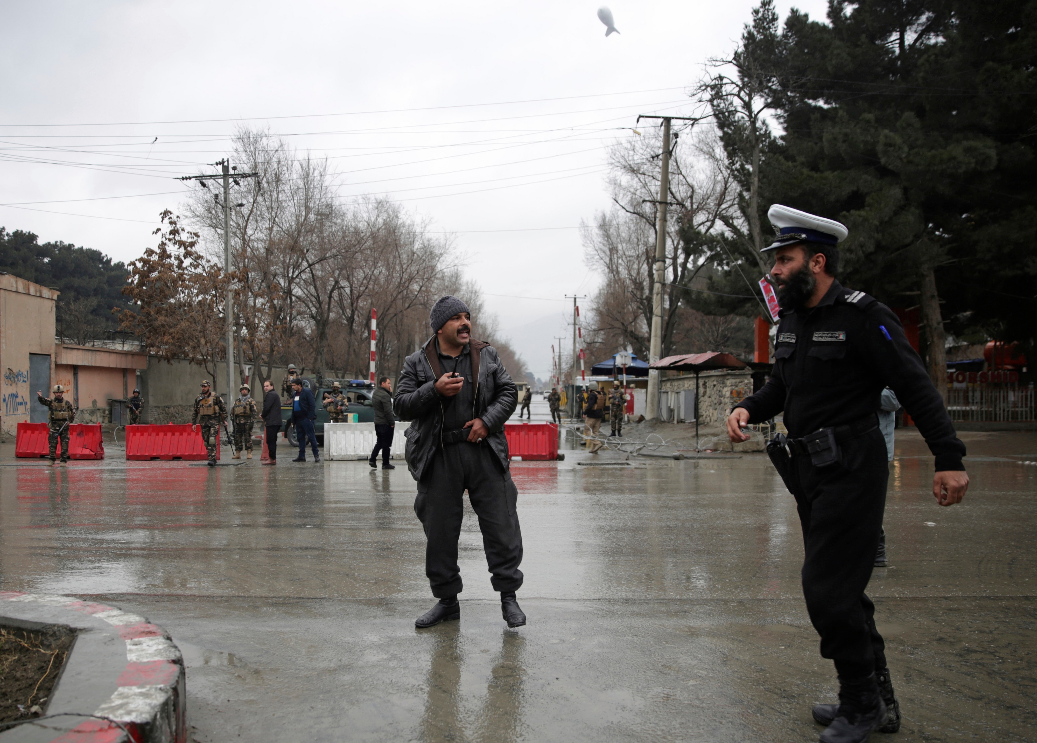 Security forces inspect the site of a suicide attack in the diplomatic area of capital Kabul.