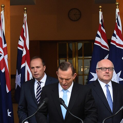 Federal Minister for for Immigration Peter Dutton, Australian Prime Minister Tony Abbott and Attorney-General George Brandis at a press conference at Parliament House in Canberra, Tuesday, June 23, 2015.  (AAP Image/Mick Tsikas) NO ARCHIVING
